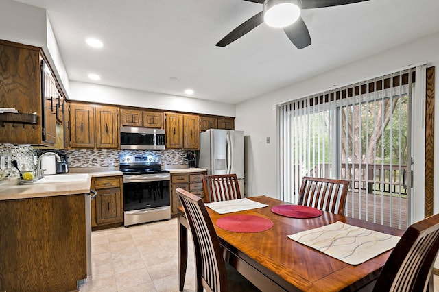 8474 Sunnyside Rd, Mounds View, MN 55112 - kitchen featuring stainless steel appliances, a sink, tasteful backsplash, light countertops, and ceiling fan