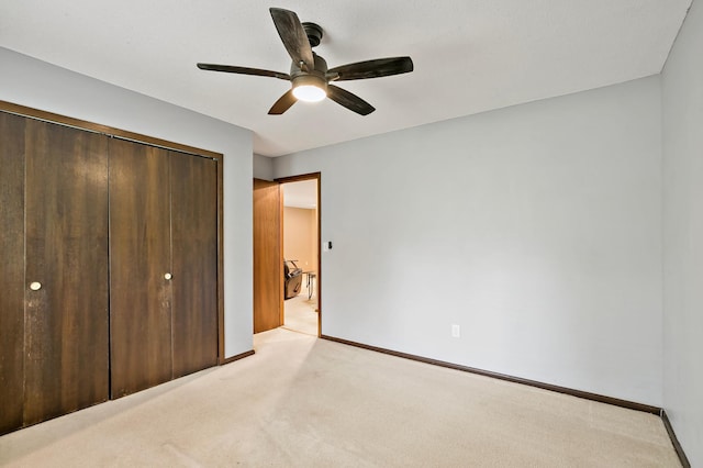 8474 Sunnyside Rd, Mounds View, MN 55112 - unfurnished bedroom featuring light carpet, a closet, baseboards, and ceiling fan