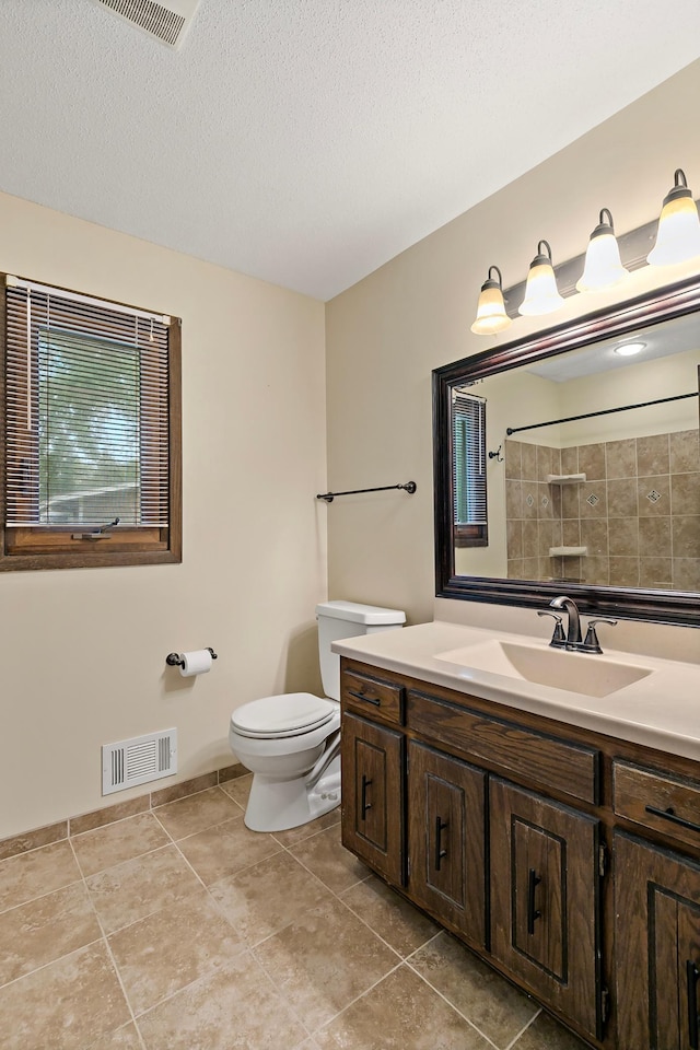 8474 Sunnyside Rd, Mounds View, MN 55112 - full bath with toilet, vanity, a shower, tile patterned floors, and a textured ceiling