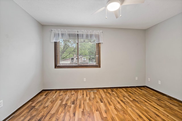 8474 Sunnyside Rd, Mounds View, MN 55112 - spare room featuring wood finished floors, a ceiling fan, and baseboards