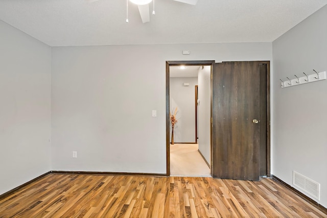 8474 Sunnyside Rd, Mounds View, MN 55112 - unfurnished bedroom with light wood-type flooring, baseboards, a ceiling fan, and a closet