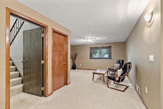 8474 Sunnyside Rd, Mounds View, MN 55112 - sitting room featuring carpet, stairs, and baseboards