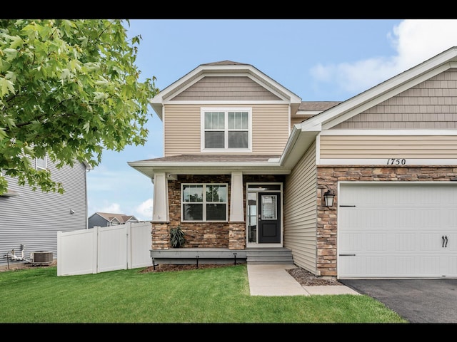 1750 Astoria Dr, Shakopee, MN 55379 - craftsman-style home featuring stone siding, central air condition unit, roof with shingles, an attached garage, and driveway