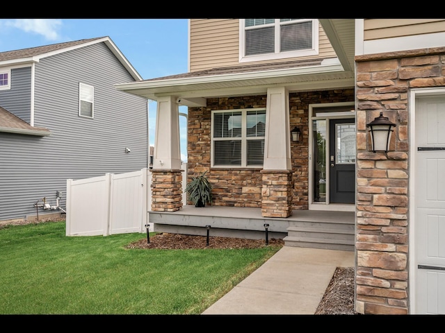1750 Astoria Dr, Shakopee, MN 55379 - doorway to property with stone siding, covered porch, and a lawn