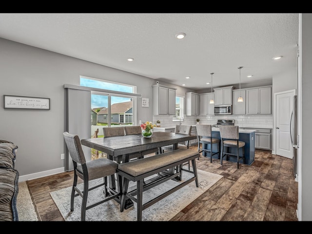 1750 Astoria Dr, Shakopee, MN 55379 - dining area featuring dark wood-style flooring, recessed lighting, baseboards, and a textured ceiling