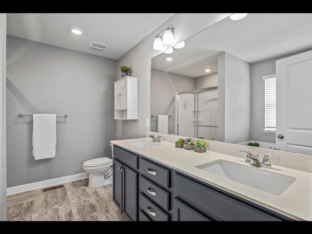 1750 Astoria Dr, Shakopee, MN 55379 - bathroom featuring double vanity, a shower stall, baseboards, and toilet