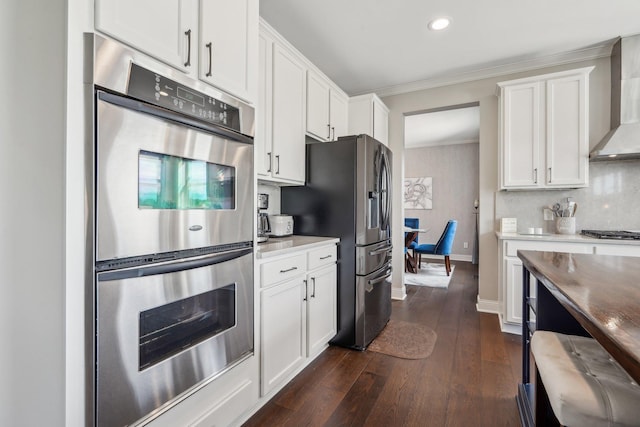 13543 Athena Way, Rosemount, MN 55068 - kitchen with stainless steel appliances, wall chimney range hood, ornamental molding, white cabinets, and dark wood-type flooring