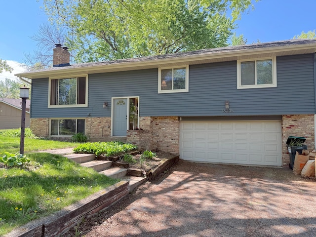 16205 5th Ave N, Plymouth, MN 55447 - raised ranch featuring brick siding, a garage, a chimney, and driveway