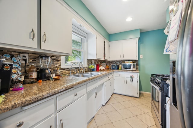 6407 Emerson Ave N, Brooklyn Center, MN 55430 - kitchen with stainless steel appliances, a sink, tasteful backsplash, light tile patterned floors, and white cabinets