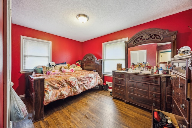 6407 Emerson Ave N, Brooklyn Center, MN 55430 - bedroom with multiple windows, wood finished floors, and a textured ceiling