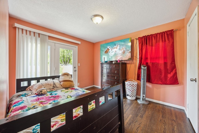 6407 Emerson Ave N, Brooklyn Center, MN 55430 - bedroom with wood finished floors, baseboards, and a textured ceiling
