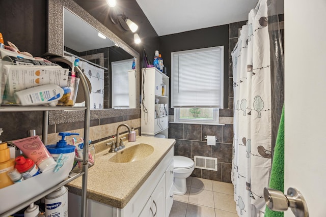 6407 Emerson Ave N, Brooklyn Center, MN 55430 - bathroom featuring tile walls, tile patterned flooring, vanity, toilet, and a shower with curtain