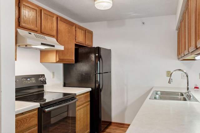 1225 Ferndale St N Unit B16, Maplewood, MN 55119 - kitchen featuring under cabinet range hood, black appliances, a sink, light countertops, and brown cabinetry