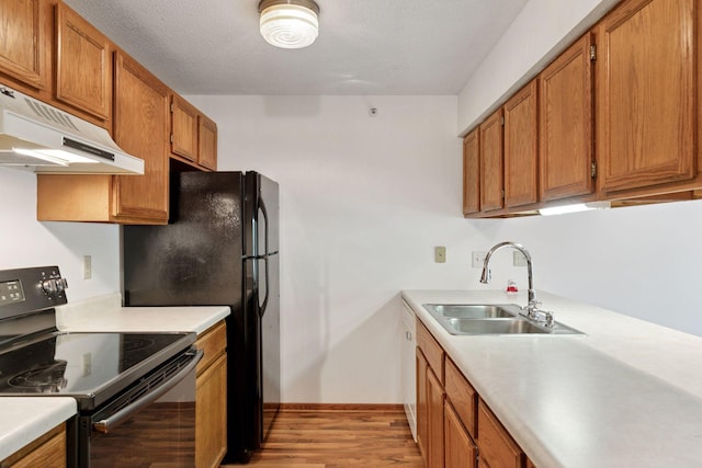 1225 Ferndale St N Unit B16, Maplewood, MN 55119 - kitchen featuring black range with electric stovetop, a sink, under cabinet range hood, and light countertops