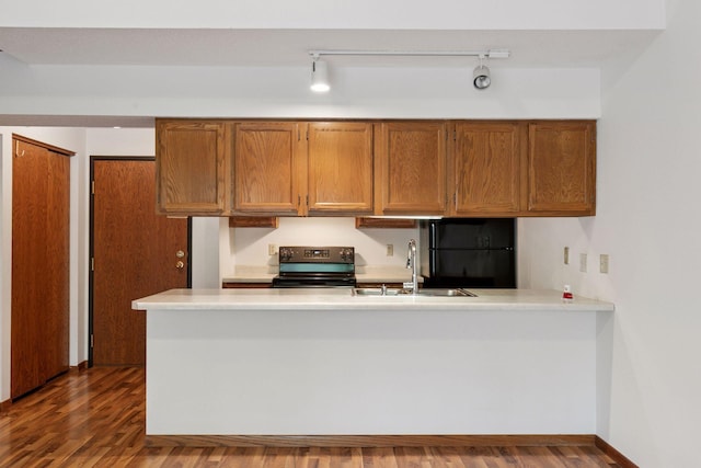 1225 Ferndale St N Unit B16, Maplewood, MN 55119 - kitchen featuring electric stove, freestanding refrigerator, a sink, brown cabinetry, and dark wood finished floors