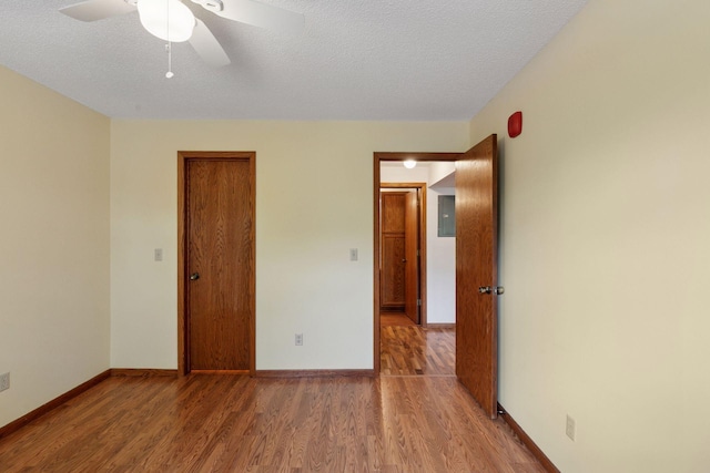 1225 Ferndale St N Unit B16, Maplewood, MN 55119 - unfurnished bedroom with wood finished floors, baseboards, a textured ceiling, and a ceiling fan