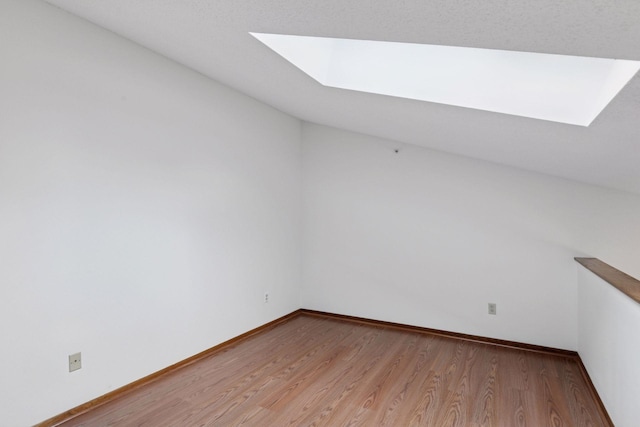 1225 Ferndale St N Unit B16, Maplewood, MN 55119 - bonus room featuring a skylight, light wood-style flooring, and baseboards
