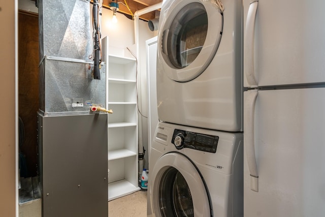 13914 Elmer Hanson Dr SE, Woodside Twp, MN 56736 - laundry room featuring stacked washer and clothes dryer and heating unit
