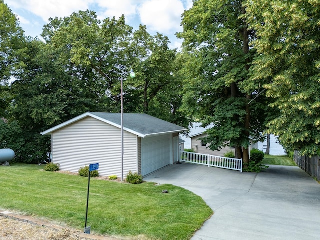 13914 Elmer Hanson Dr SE, Woodside Twp, MN 56736 - view of side of home with a garage, an outdoor structure, a yard, and roof with shingles