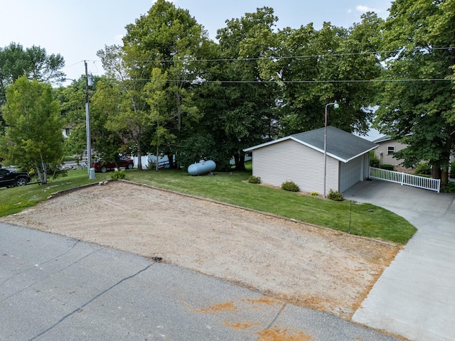 13914 Elmer Hanson Dr SE, Woodside Twp, MN 56736 - view of green lawn with concrete driveway and an outdoor structure