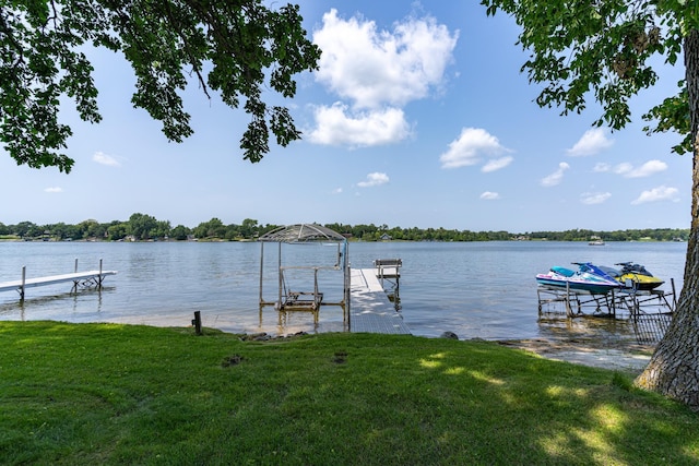 13914 Elmer Hanson Dr SE, Woodside Twp, MN 56736 - dock with boat lift, a water view, and a yard