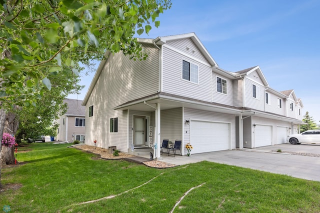 5512 Bishops Blvd S Unit D, Fargo, ND 58104 - view of front of property featuring an attached garage, a front yard, and driveway