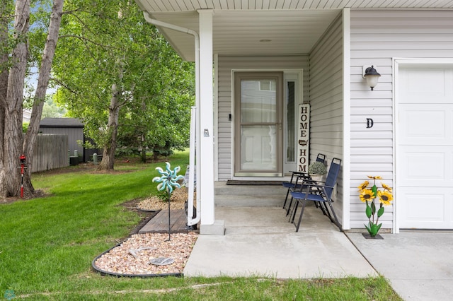 5512 Bishops Blvd S Unit D, Fargo, ND 58104 - doorway to property featuring a lawn and covered porch