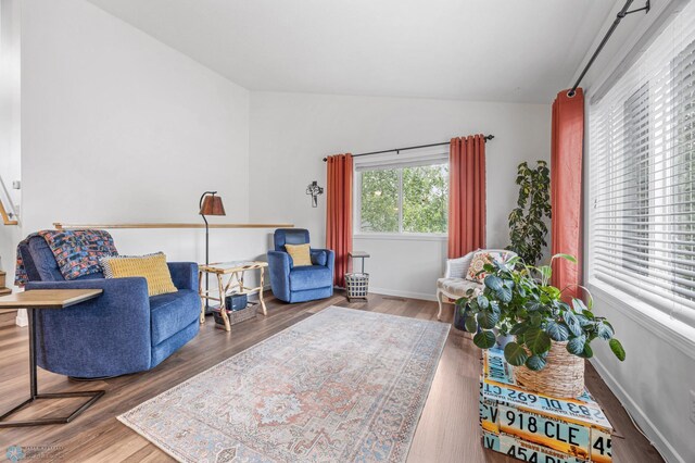 5512 Bishops Blvd S Unit D, Fargo, ND 58104 - living area with lofted ceiling, wood finished floors, and baseboards