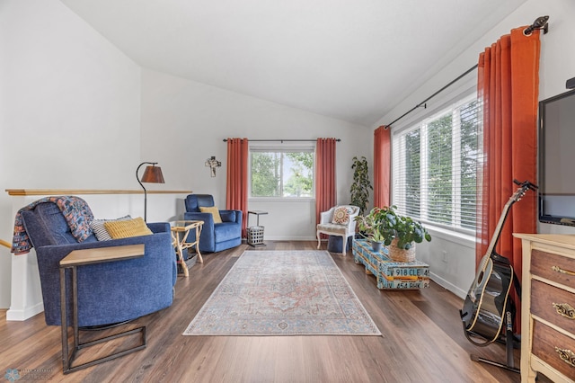 5512 Bishops Blvd S Unit D, Fargo, ND 58104 - living area with vaulted ceiling, wood finished floors, and baseboards