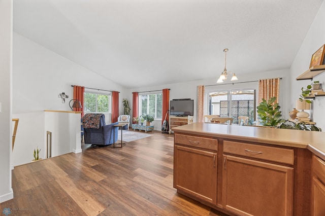 5512 Bishops Blvd S Unit D, Fargo, ND 58104 - kitchen featuring a chandelier, open floor plan, dark wood-style floors, lofted ceiling, and light countertops