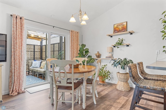 5512 Bishops Blvd S Unit D, Fargo, ND 58104 - dining space with lofted ceiling, wood finished floors, a chandelier, and baseboards