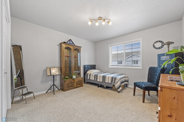 5512 Bishops Blvd S Unit D, Fargo, ND 58104 - carpeted bedroom featuring baseboards and a textured ceiling