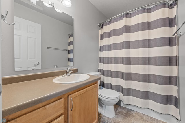 5512 Bishops Blvd S Unit D, Fargo, ND 58104 - bathroom with toilet, vanity, curtained shower, and stone finish flooring
