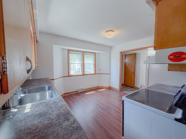 938 Selby Ave, Saint Paul Park, MN 55071 - kitchen with white electric stove, wood finished floors, a sink, and baseboards