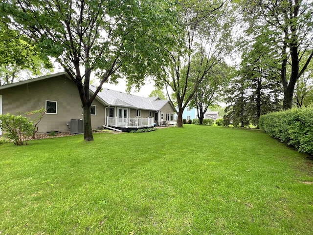 1715 Hansen Dr SW, Willmar, MN 56201 - view of grassy yard featuring central AC unit and a wooden deck