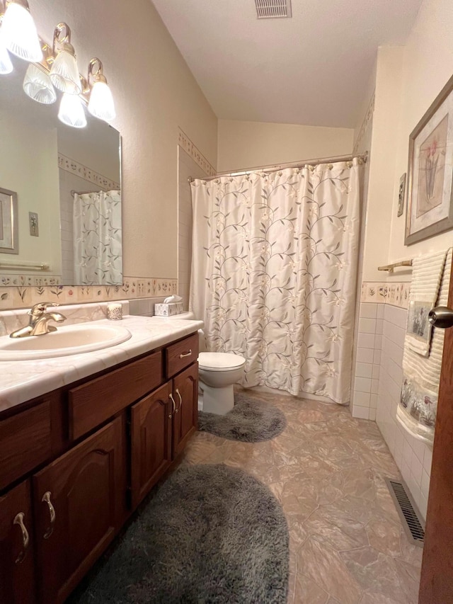 1715 Hansen Dr SW, Willmar, MN 56201 - bathroom featuring toilet, vanity, lofted ceiling, and curtained shower