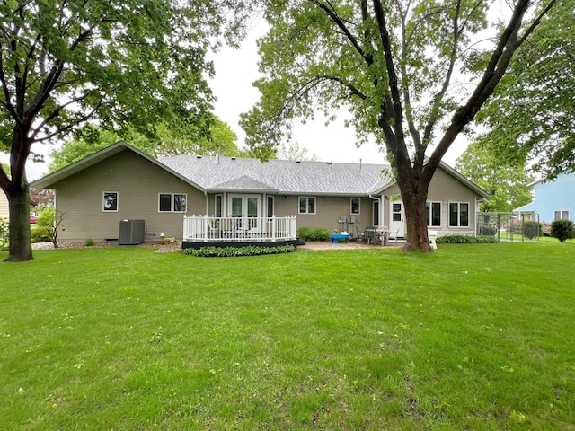 1715 Hansen Dr SW, Willmar, MN 56201 - rear view of house featuring central air condition unit, a yard, a wooden deck, and a patio