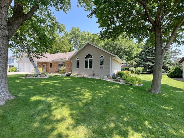 1715 Hansen Dr SW, Willmar, MN 56201 - rear view of property with an attached garage and a lawn