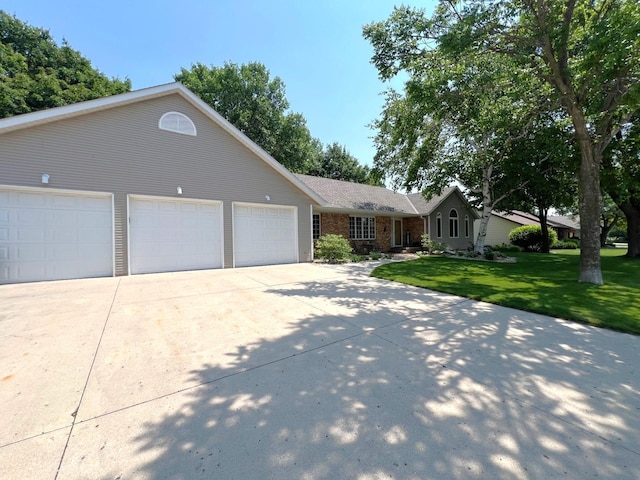 1715 Hansen Dr SW, Willmar, MN 56201 - ranch-style home featuring driveway, a front lawn, an attached garage, and brick siding