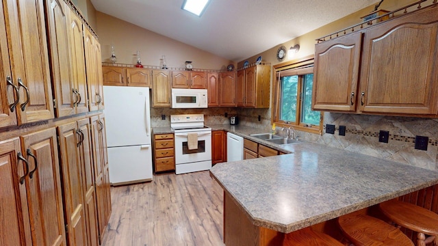 1715 Hansen Dr SW, Willmar, MN 56201 - kitchen with white appliances, lofted ceiling, a peninsula, light wood-style floors, and backsplash