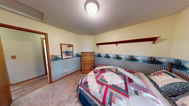 1715 Hansen Dr SW, Willmar, MN 56201 - carpeted bedroom featuring a textured ceiling and baseboards