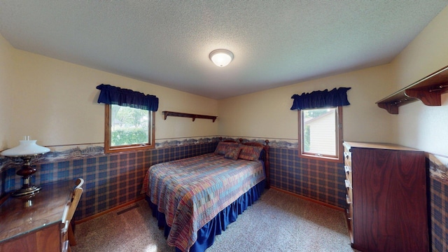 1715 Hansen Dr SW, Willmar, MN 56201 - carpeted bedroom featuring a wainscoted wall and a textured ceiling