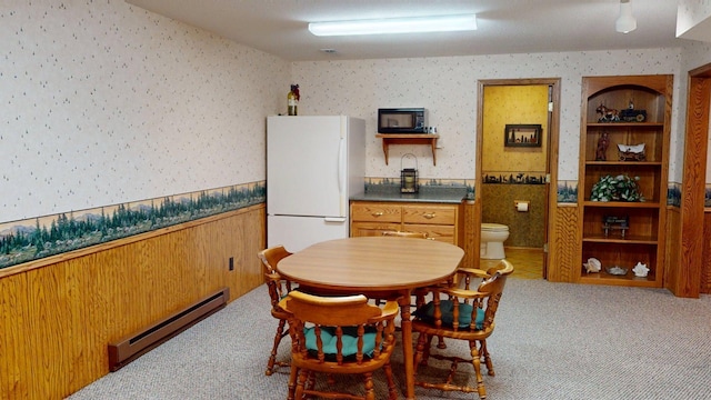 1715 Hansen Dr SW, Willmar, MN 56201 - carpeted dining space featuring wallpapered walls and a baseboard radiator
