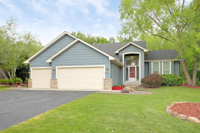 22669 128th Ave N, Rogers, MN 55374 - view of front of home featuring driveway, a garage, and a front yard