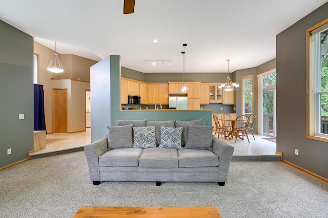22669 128th Ave N, Rogers, MN 55374 - living area with light carpet, baseboards, a chandelier, ceiling fan, and rail lighting