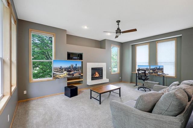 22669 128th Ave N, Rogers, MN 55374 - carpeted living room with baseboards, a ceiling fan, and a warm lit fireplace
