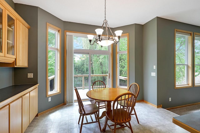 22669 128th Ave N, Rogers, MN 55374 - dining room with healthy amount of natural light, a chandelier, baseboards, and light flooring