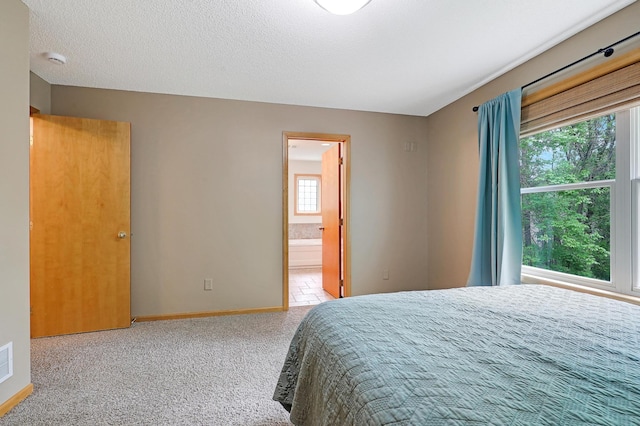 22669 128th Ave N, Rogers, MN 55374 - carpeted bedroom with baseboards and ensuite bath