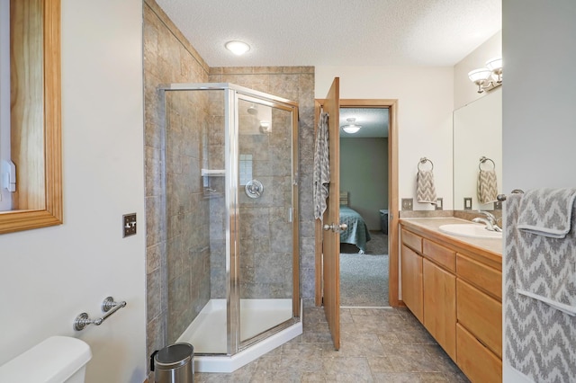 22669 128th Ave N, Rogers, MN 55374 - bathroom featuring a textured ceiling, vanity, a stall shower, connected bathroom, and toilet