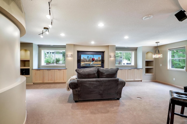 22669 128th Ave N, Rogers, MN 55374 - living area featuring light carpet, healthy amount of natural light, track lighting, baseboards, and a textured ceiling